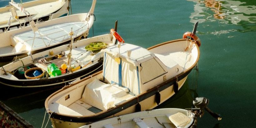 photo by grigorii shcheglov Boats are docked in calm, clear water.